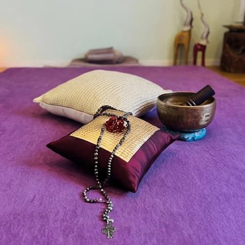 Heart picture on the wall next to a curtain and a prepared massage mat