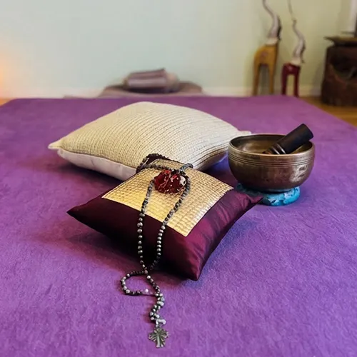 Heart picture on the wall next to a curtain and a prepared massage mat